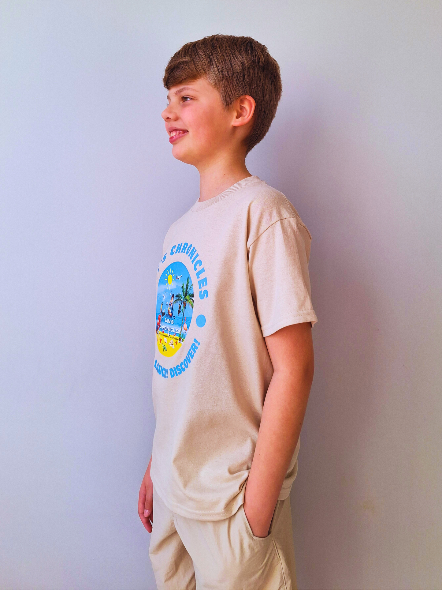 San’s Chronicles™ Official T-Shirt – Wear the Adventure! 🎉👕 Beige
